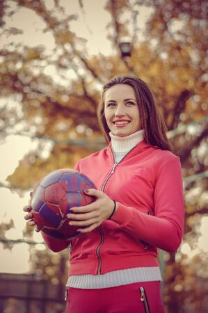 Girl holding a soccer ball. Portrait of vintage style.の写真素材