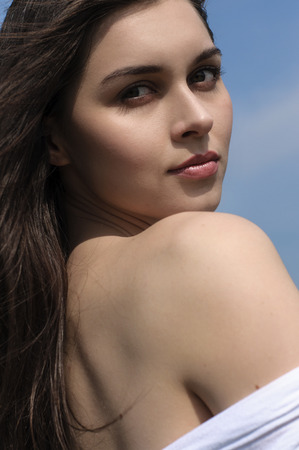 Portrait of a girl against the blue sky. Concept: freedom, health, cleanliness.の写真素材