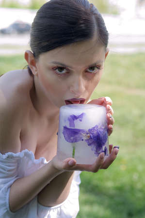 Fashion portrait of a girl who eats strange food instead of natural productsの写真素材