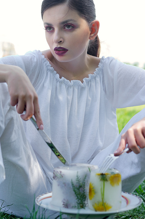 Fashion portrait of a girl who eats frozen artificial foodの写真素材