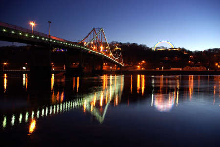 Foot bridge cross the Dniper river and rainbow Friendship of nations, Kiev, Ukraine  の写真素材