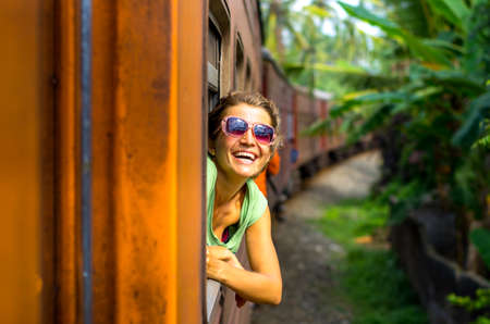 Young woman traveling by train in Sri Lankaの写真素材