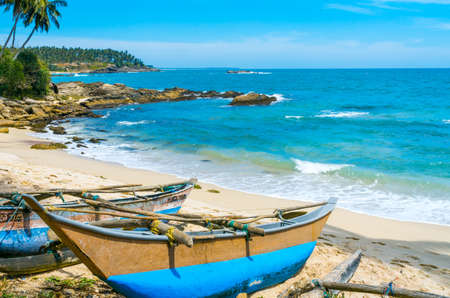 Boats landed at the Tropical beach in Sri Lankaの写真素材