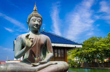Blessing Buddha in Gangarama Buddhist Temple, Sri Lankaの写真素材