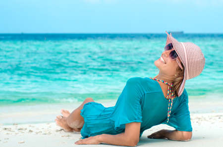 Young beautiful woman relaxing on a beachの写真素材