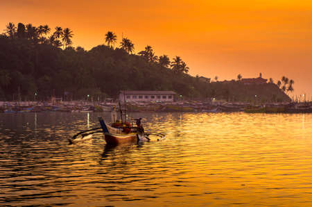 Silhouettes of the traditional fishermen at the sunset in Sri Lankaの写真素材