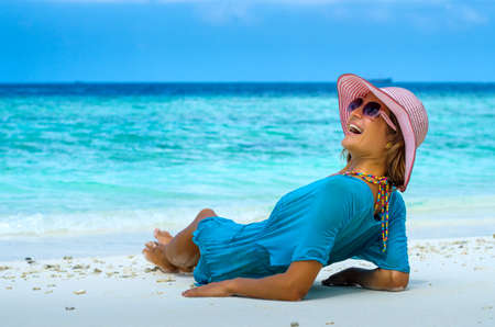 Young beautiful woman relaxing on a beachの写真素材