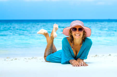 Young beautiful woman relaxing on a beachの写真素材