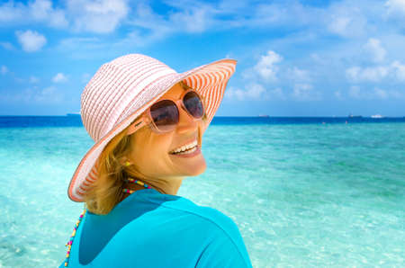 Young beautiful woman relaxing on a beachの写真素材