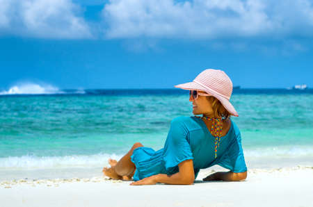 Young beautiful woman relaxing on a beachの写真素材