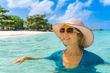 Young beautiful woman relaxing on a Maldives beachの写真素材