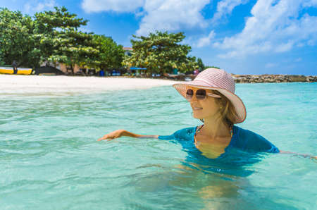Young beautiful woman relaxing on a Maldives beachの写真素材