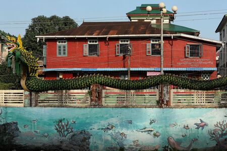 Green dragon set on the blue wall decorated as the blue sea is in front of the colorful shophouse.のeditorial素材