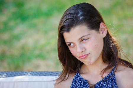 girl looking sad . Closeup portrait beautiful kid with long hair.の写真素材