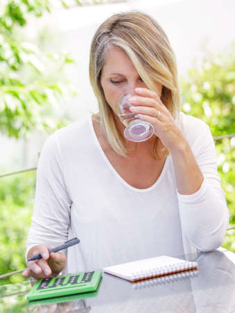 middle aged blond woman working at home without stress