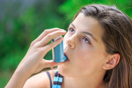 Portrait of a girl using asthma inhalerの写真素材