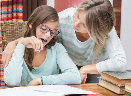 pretty student girl taking tutoring courses with beautiful blond teacher
