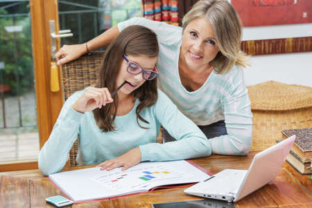 pretty student girl taking tutoring courses with beautiful blond teacher