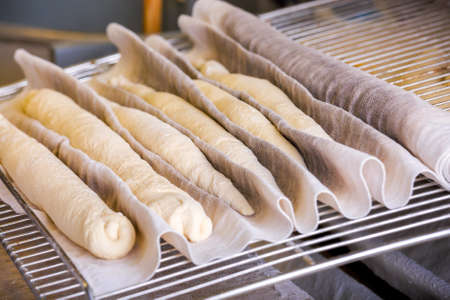 A plain baguette ready to bake on baking tray