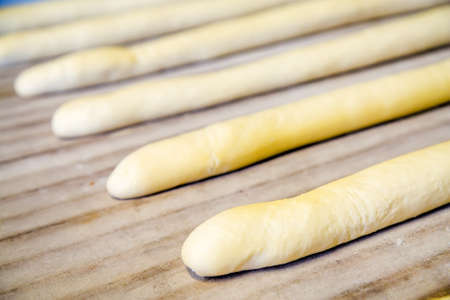 A plain baguette ready to bake on baking tray