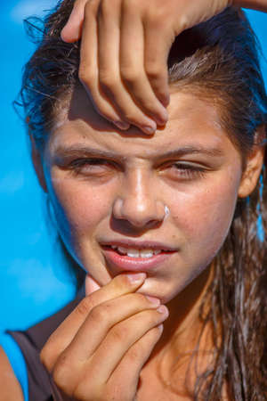 Protect sunscreen applied to the face of cute young girlの写真素材