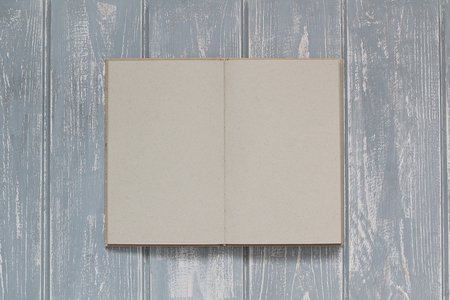 Note book on grey wooden desk. Top view.