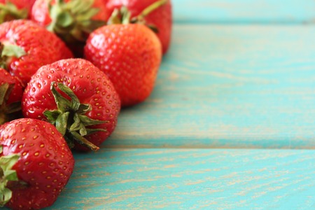 Strawberries on wooden blue desk. Stock photo.の写真素材