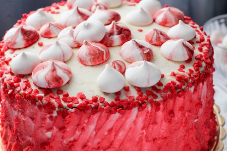Red homemade cake decorated by hearts.