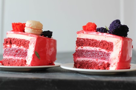 Red velvet. Tasty red homemade cake decorated by macarons. Modern photo