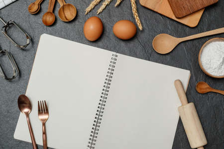 Top view black table with eggs, flour and utensils. Copy space for textの写真素材