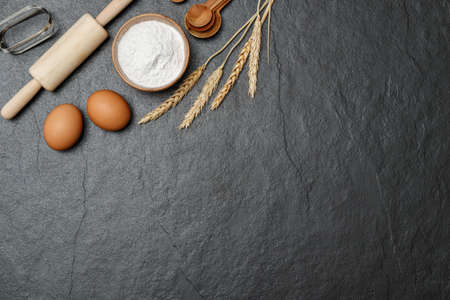 Top view black table with eggs, flour and utensils. Copy space for textの写真素材
