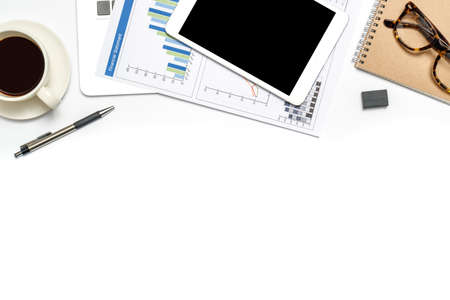 Workspace showing business and financial report on isolate background with notebook, coffee, and accessories. Top view with copy space, flat lay.の写真素材