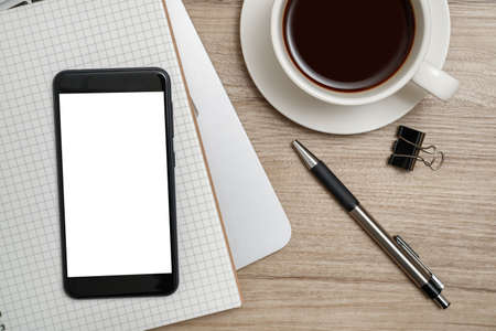 Top view workspace  on wooden desk with tablet, notebook, pen and a cup of coffee.