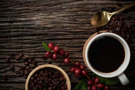 Top view mockup a cup of coffee and coffee beans in the bowl on the wooden desk.の写真素材