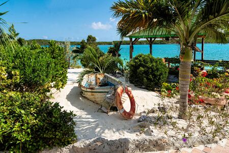 A deserted boat sits upon a sandy beach.の写真素材