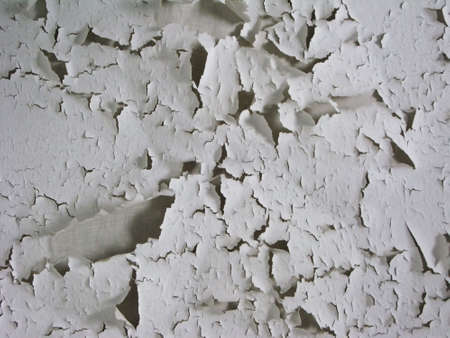Cracked white paint on a wall. Indoor scenery.の写真素材