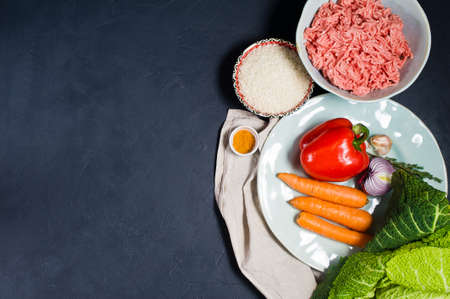 Ingredients for Savoy cabbage rolls. Carrots, bell peppers, onions, garlic, thyme, spices, rice,...