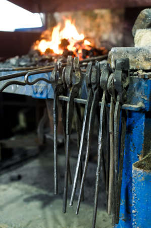 The blacksmith melt metal in a furnace, an authentic forgeの写真素材
