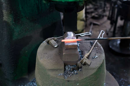 Blacksmith forges in hydraulic pressの写真素材