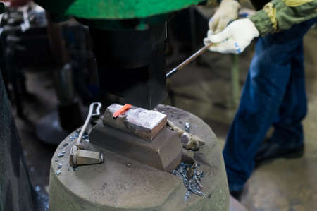 Blacksmith forges in hydraulic pressの写真素材