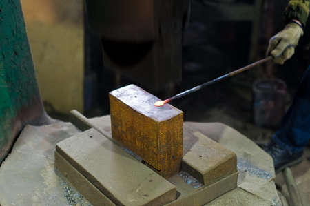 Blacksmith forges in hydraulic pressの写真素材