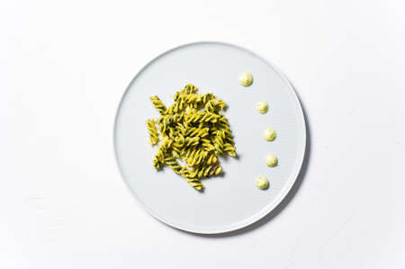 Gluten-free pasta with spinach. Diet dish. White background, top view, space for textの写真素材
