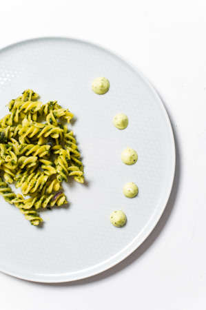 Gluten-free pasta with spinach. Diet dish. White background, top view, space for textの写真素材