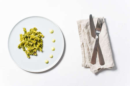 Gluten-free pasta with spinach. Diet dish. Minimalism. White background, top viewの写真素材