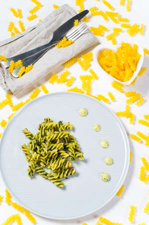 Gluten-free pasta with spinach, concept. Diet dish.. White background, top viewの写真素材