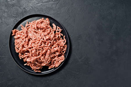 Raw minced on a stone Board. Black background, top view, space for textÑの写真素材