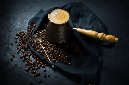 Coffee in Turk, coffee beans. Black background, top view, space for textの写真素材