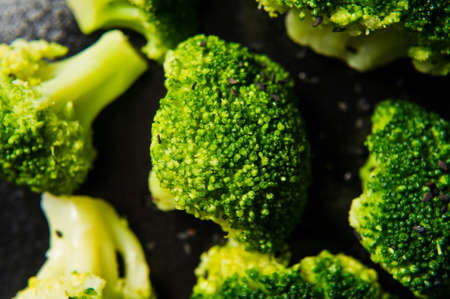 Broccoli on a black plate. Black background, side view, close-upの写真素材