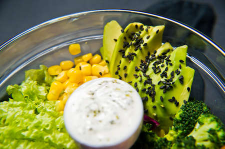 Vegetarian dish, salad bowl. Ingredients broccoli, corn, carrots, couscous, lettuce, cabbage, sauce....