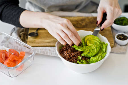 The chef prepares a Poke bowl. White background, side viewの写真素材